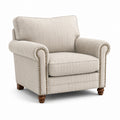 Fauteuil en lin beige avec accoudoirs arrondis et clous décoratifs